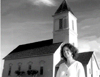 Rabbi Margaret Holub in front of the Jewish Temple in Caspar.